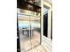 A stainless steel, side-by-side refrigerator with water dispenser and dark wood cabinets in a kitchen at 2454 W Hope Cir, Chandler, AZ 85248