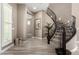 Elegant curved staircase with dark wood railings and carpeted steps at 2454 W Hope Cir, Chandler, AZ 85248