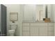 Contemporary bathroom featuring modern fixtures, white vanity, and plenty of natural light at 25162 N 177Th Dr, Surprise, AZ 85387