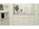 Bathroom vanity featuring white cabinets, stylish vases, and a large mirror at 25162 N 177Th Dr, Surprise, AZ 85387