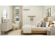 Bright bedroom featuring a dresser, a modern lamp, and a neutral patterned floor at 25162 N 177Th Dr, Surprise, AZ 85387