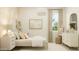 Bright bedroom featuring a white dresser, modern decorations, and a neutral patterned floor at 25162 N 177Th Dr, Surprise, AZ 85387