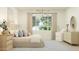 Relaxing bedroom with a large window, stylish decor, and a comfortable seating area by the window at 25162 N 177Th Dr, Surprise, AZ 85387