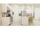 Well-equipped kitchen featuring white cabinets, stainless steel appliances, an island, and pendant lights at 25162 N 177Th Dr, Surprise, AZ 85387