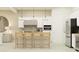Modern kitchen with stainless steel appliances, white cabinetry, pendant lighting, and a breakfast bar at 25162 N 177Th Dr, Surprise, AZ 85387