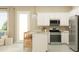 Modern kitchen with stainless steel appliances, an island with bar stools, and bright lighting at 25162 N 177Th Dr, Surprise, AZ 85387