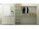 Modern walk-in closet and integrated vanity featuring ample storage and contemporary design at 25162 N 177Th Dr, Surprise, AZ 85387