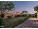 Backyard with well-kept lawn, privacy landscaping, and block fencing at dusk at 2557 N Springfield St, Buckeye, AZ 85396