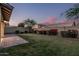 Scenic backyard featuring lush greenery, mature trees, colorful bushes, and block fencing at 2557 N Springfield St, Buckeye, AZ 85396