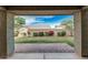 Backyard view showcasing a covered patio, a manicured lawn, block fence and garden at 2557 N Springfield St, Buckeye, AZ 85396