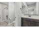 Modern bathroom showcases vanity with dark bronze accents, bathtub, and toilet at 2557 N Springfield St, Buckeye, AZ 85396
