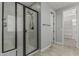The bathroom showcases a glass-enclosed shower with dark bronze features and a tiled floor at 2557 N Springfield St, Buckeye, AZ 85396