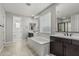 Bathroom with large tub, dual vanity, and walk-in shower provides a relaxing oasis at 2557 N Springfield St, Buckeye, AZ 85396