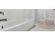 Clean white bathroom shows a tub with modern fixtures, tiled floors, and toilet at 2557 N Springfield St, Buckeye, AZ 85396
