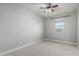 Cozy bedroom has neutral carpet, paint, ceiling fan, and a window providing plenty of natural light at 2557 N Springfield St, Buckeye, AZ 85396