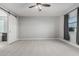Large bedroom with neutral carpet, barn door, and a large window offers ample space at 2557 N Springfield St, Buckeye, AZ 85396