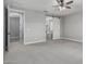Bedroom with neutral carpet, barn door access to the bath, and doorway to another room at 2557 N Springfield St, Buckeye, AZ 85396