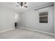 Light-filled bedroom boasts neutral tones, plush carpeting, and a window offering natural light and a view at 2557 N Springfield St, Buckeye, AZ 85396
