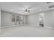 Spacious bedroom with carpeting, ceiling fan, and curtains offering plenty of natural light at 2557 N Springfield St, Buckeye, AZ 85396