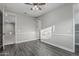 Large bedroom featuring hardwood flooring, a ceiling fan, and multiple entrances for convenience at 2557 N Springfield St, Buckeye, AZ 85396