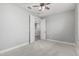 Neutral bedroom with ceiling fan features double doors leading to the hallway at 2557 N Springfield St, Buckeye, AZ 85396