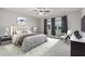This stylish bedroom features a neutral color palette, a plush bed, and ample natural light at 2557 N Springfield St, Buckeye, AZ 85396