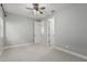 Bright bedroom featuring neutral walls, carpet, a ceiling fan, and an adjoining room for versatile use at 2557 N Springfield St, Buckeye, AZ 85396