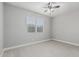 This bedroom is neutral with a ceiling fan and a window with blinds at 2557 N Springfield St, Buckeye, AZ 85396