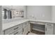 Bright home office space features white cabinets, drawers, and a pass-through window to the kitchen at 2557 N Springfield St, Buckeye, AZ 85396