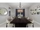 Elegant dining room with large wood table, chandelier, and artwork enhancing the inviting space at 2557 N Springfield St, Buckeye, AZ 85396
