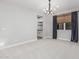 Bright dining room features modern chandelier, window with shade, and neutral walls at 2557 N Springfield St, Buckeye, AZ 85396