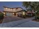 Inviting exterior view of a two-story home with a double garage and well-maintained landscaping at 2557 N Springfield St, Buckeye, AZ 85396