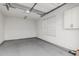 Spacious two-car garage with painted floors, shelving, and a window for natural light at 2557 N Springfield St, Buckeye, AZ 85396