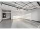 Large two-car garage features painted floors, utility sink, water heater, and overhead storage racks at 2557 N Springfield St, Buckeye, AZ 85396