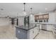Spacious kitchen with large island, pendant lighting, and stainless steel appliances at 2557 N Springfield St, Buckeye, AZ 85396