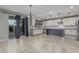 Bright eat-in kitchen with island, stainless appliances and sliding glass doors to the backyard at 2557 N Springfield St, Buckeye, AZ 85396