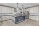 Spacious kitchen features white cabinetry, stainless steel appliances, and a gray island at 2557 N Springfield St, Buckeye, AZ 85396