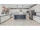 Open kitchen with large island, stainless steel appliances, and ample white cabinetry at 2557 N Springfield St, Buckeye, AZ 85396