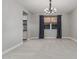 Neutral living space with carpet and large windows at 2557 N Springfield St, Buckeye, AZ 85396