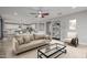 Cozy living room with plush sofa, modern decor, and an open view to the kitchen at 2557 N Springfield St, Buckeye, AZ 85396