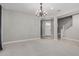 Open-concept living room with neutral paint and carpet, brightened by natural light from the entrance at 2557 N Springfield St, Buckeye, AZ 85396