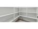 Walk-in pantry with white shelving providing ample storage space at 2557 N Springfield St, Buckeye, AZ 85396