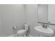 Clean powder room with pedestal sink, neutral colors, and a modern mirror at 2557 N Springfield St, Buckeye, AZ 85396