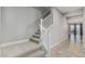 Interior view featuring a carpeted staircase with white railings leading to the upper level at 2557 N Springfield St, Buckeye, AZ 85396
