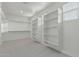 Spacious walk-in closet with wall-to-wall shelving for organizing clothes and shoes at 2557 N Springfield St, Buckeye, AZ 85396