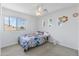 Cozy bedroom features a bright window with neighborhood views and a floral comforter set at 285 W Goldfinch Way, Chandler, AZ 85286