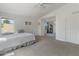 Bright, carpeted bedroom featuring a ceiling fan and large window with neighborhood views at 285 W Goldfinch Way, Chandler, AZ 85286