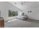 Bright carpeted bedroom featuring large windows, neutral walls, and ceiling fan at 285 W Goldfinch Way, Chandler, AZ 85286