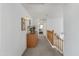 Upstairs hallway with wood railing, side table decor, and carpet at 285 W Goldfinch Way, Chandler, AZ 85286