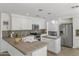 Clean kitchen with tile countertops, stainless steel appliances, white cabinets, and an island sink at 285 W Goldfinch Way, Chandler, AZ 85286